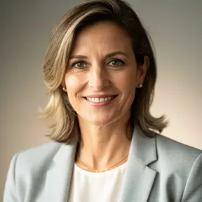 Professional headshot of a French woman in her early 40s, natural light, soft neutral background, warm and confident smile, smart casual outfit, realistic photography, shallow depth of field, high resolution
